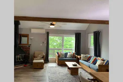 a living room with a couch and a fireplace at Just renovated Camelback SKI-ON/OFF,SNOW TUBING,PAINTBALL in Tannersville