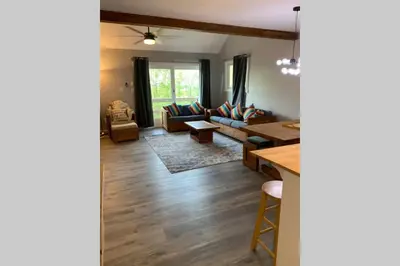 a living room with a couch and a table at Just renovated Camelback SKI-ON/OFF,SNOW TUBING,PAINTBALL in Tannersville