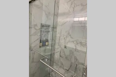a bathroom with a shower with a glass door at Just renovated Camelback SKI-ON/OFF,SNOW TUBING,PAINTBALL in Tannersville