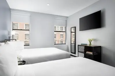 a hotel room with two beds and a flat screen tv at OYO Times Square in New York