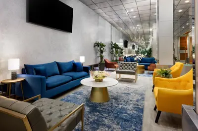 a lobby with blue couches and yellow chairs at OYO Times Square in New York