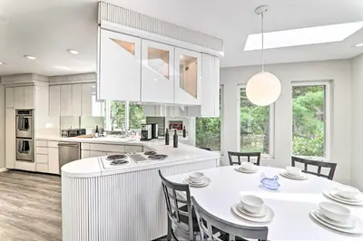 a kitchen with white cabinets and a white table and chairs at Game Room! Poconos Paradise 10 Mi to Ski Slopes in East Stroudsburg