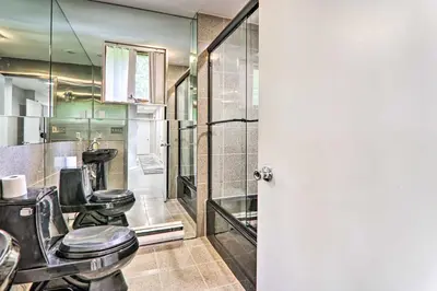 a bathroom with two toilets and a shower at Game Room! Poconos Paradise 10 Mi to Ski Slopes in East Stroudsburg