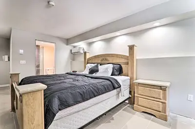 a bedroom with a large bed with a wooden frame at Game Room! Poconos Paradise 10 Mi to Ski Slopes in East Stroudsburg