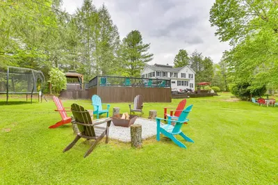 a group of chairs sitting around a fire pit in a yard at Game Room and Yard Greentown Home Near State Park in Greentown
