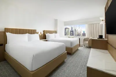 a hotel room with two beds and a television at Hyatt Regency Times Square in New York
