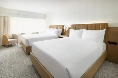 a hotel room with two beds and a chair at Hyatt Regency Times Square in New York