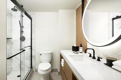 a bathroom with a toilet and a mirror at Hyatt Regency Times Square in New York