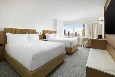 a hotel room with two beds and a television at Hyatt Regency Times Square in New York