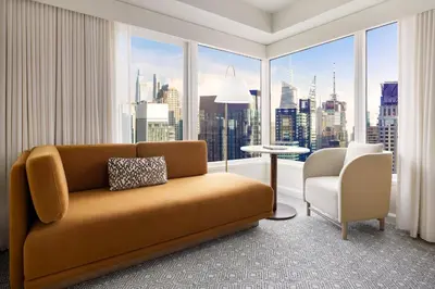 a living room with a couch and a large window at Hyatt Regency Times Square in New York