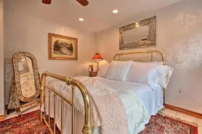 a bedroom with a bed and a mirror at Lakefront Poconos Retreat with Hot Tub, Near Hiking! in Bear Creek Village