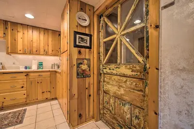 a kitchen with a large wooden door in a room at Lakefront Poconos Retreat with Hot Tub, Near Hiking! in Bear Creek Village