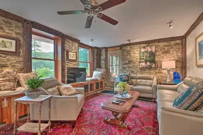 a living room with a couch and a tv at Lakefront Poconos Retreat with Hot Tub, Near Hiking! in Bear Creek Village