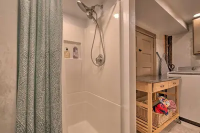 a bathroom with a shower with a shower curtain at Lakefront Poconos Retreat with Hot Tub, Near Hiking! in Bear Creek Village