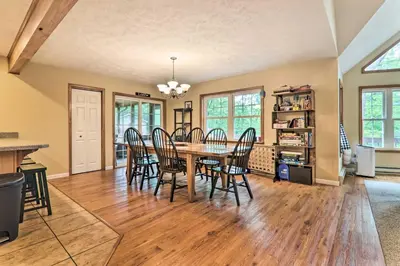 a dining room with a table and chairs at Steps to River Big Bass Lake House with Grill! in Gouldsboro