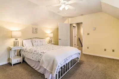 a bedroom with a bed and a ceiling fan at Steps to River Big Bass Lake House with Grill! in Gouldsboro