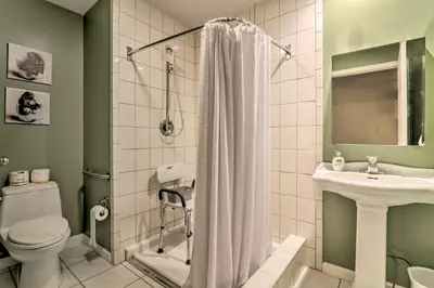 a bathroom with a toilet and a sink and a shower at Steps to River Big Bass Lake House with Grill! in Gouldsboro