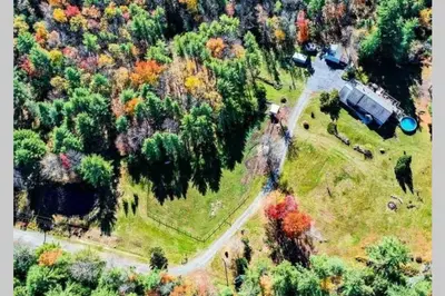 an aerial view of a house in a forest at Southwoods Mountain Estate -private mansion, pool, hottub+ 15 acres in Monticello