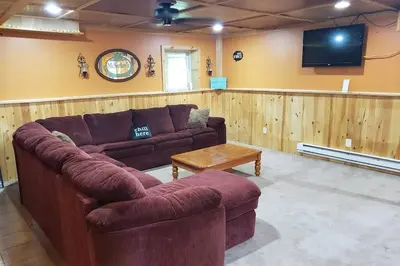 a living room with a couch and a tv at Southwoods Mountain Estate -private mansion, pool, hottub+ 15 acres in Monticello