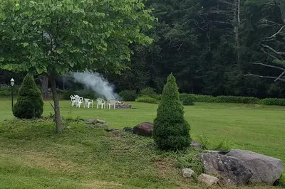 a group of tables and chairs in a park at Southwoods Mountain Estate -private mansion, pool, hottub+ 15 acres in Monticello