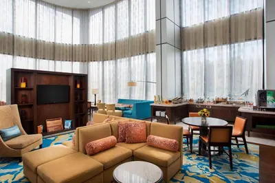 a living room with a couch and a table at Teaneck Marriott at Glenpointe in Teaneck