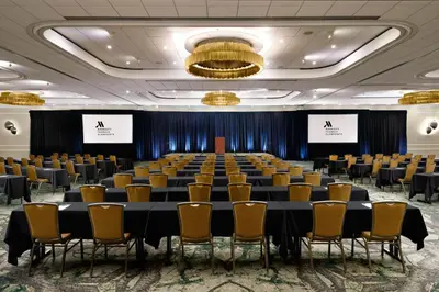 a conference room with a long table and chairs at Teaneck Marriott at Glenpointe in Teaneck