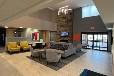 a lobby with a couch and chairs and a table at Holiday Inn Express Harrisburg I-81 - Hershey By IHG in Manadahill