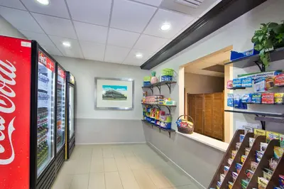 a grocery store aisle with a cocacola soda machine at Holiday Inn Express Harrisburg I-81 - Hershey By IHG in Manadahill