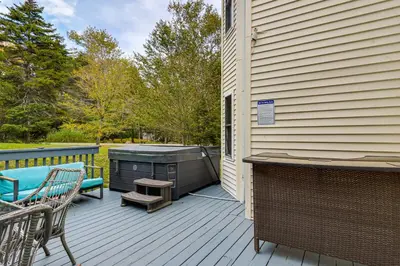 a patio with a grill and a bench on a deck at Fire Pit and Hot Tub Peaceful Poconos Farms Getaway in Tobyhanna