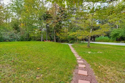 a path in a park with grass and trees at Fire Pit and Hot Tub Peaceful Poconos Farms Getaway in Tobyhanna