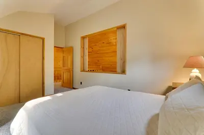 a bedroom with a white bed and a window at 2 Mi to Elk Mountain Poconos Escape on 11 Acres! in Pleasant Mount