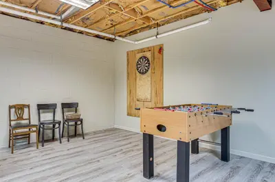 a ping pong table in a room with chairs at 2 Mi to Elk Mountain Poconos Escape on 11 Acres! in Pleasant Mount