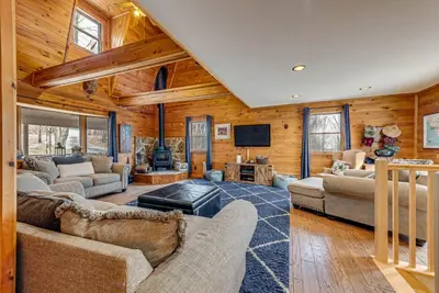 a living room with couches and a flat screen tv at 2 Mi to Elk Mountain Poconos Escape on 11 Acres! in Pleasant Mount