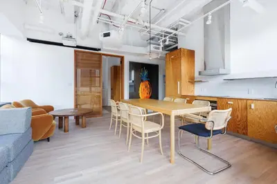 a kitchen and living room with a table and chairs at Placemakr Wall Street in New York