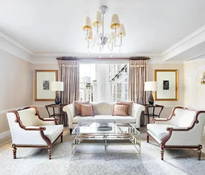 a living room with a white couch and two chairs at The Pierre, A Taj Hotel, New York in New York