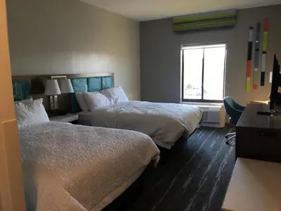 a hotel room with two beds and a window at Hampton Inn Old Bridge NJ in Old Bridge