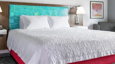 a bedroom with a large white bed with a red rug at Hampton Inn Old Bridge NJ in Old Bridge