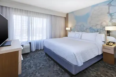 a hotel room with a bed and a flat screen tv at Courtyard by Marriott Secaucus Meadowlands in Secaucus