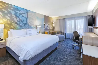 a hotel room with a bed and a desk at Courtyard by Marriott Secaucus Meadowlands in Secaucus