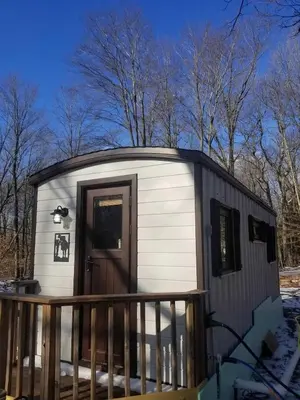 a small shed with a door on a deck at Camptel Poconos in Albrightsville