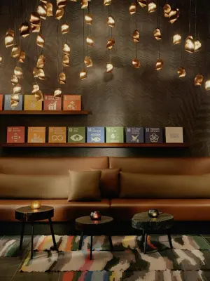 a couch in a room with two tables and lights at The Cloud One New York-Downtown, by the Motel One Group in New York