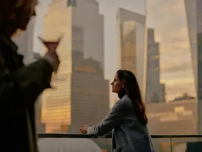 a woman taking a picture of a man in the city at The Cloud One New York-Downtown, by the Motel One Group in New York