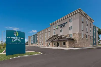 a rendering of a building with a sign in front of it at WoodSpring Suites Philadelphia Northeast in Philadelphia