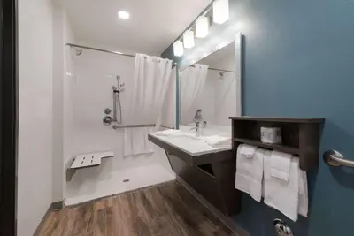a bathroom with a sink and a mirror at WoodSpring Suites Philadelphia Northeast in Philadelphia