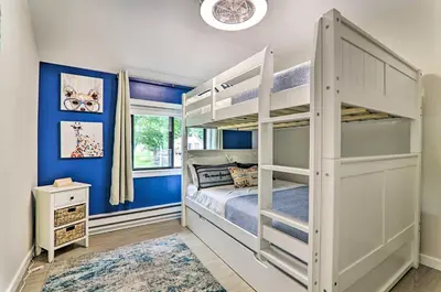 a bedroom with a bunk bed and blue walls at Relax Fireside! Retreat 15 Mi to Camelback Slopes in Tobyhanna