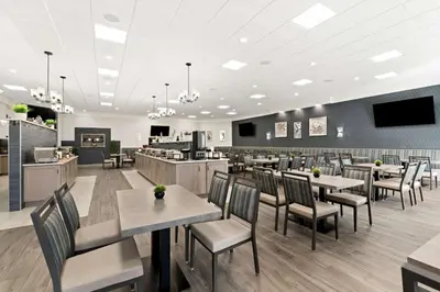a dining room with tables and chairs in a restaurant at Best Western Plus Concordville Hotel in Concordville