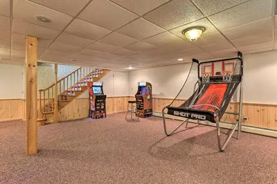 a gym with a slide in the middle of a room at Riverside Retreat in Catskill Mountains with Pool, Hot Tub & Game Room in Starlight