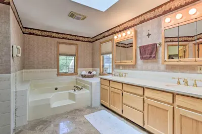 a bathroom with a tub and a sink at Riverside Retreat in Catskill Mountains with Pool, Hot Tub & Game Room in Starlight