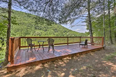 two chairs and a table on a wooden deck at Riverside Retreat in Catskill Mountains with Pool, Hot Tub & Game Room in Starlight
