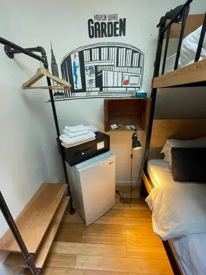a dorm room with a bunk bed and a desk at Chelsea Rooms NYC in New York